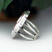 left side view, large oval wild horse magnesite gemstone silver statement ring, bezel set with stamped cutout wire accent